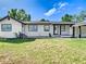 Charming single-story home featuring a well-manicured lawn, white exterior paint, and black trim at 2411 Crawford Dr, Sanford, FL 32771