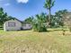 Charming home featuring a well-maintained lawn, complemented by tropical landscaping and convenient carport at 2411 Crawford Dr, Sanford, FL 32771