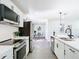 Modern kitchen featuring stainless steel appliances, white cabinets, and hardwood floors at 2411 Crawford Dr, Sanford, FL 32771