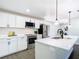 Well-lit kitchen with stainless appliances, white quartz countertops, and stylish lighting fixtures at 2411 Crawford Dr, Sanford, FL 32771