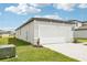 Charming exterior of the house featuring a two-car garage and a well-maintained lawn and landscaping at 2511 Linda Knoll Ln, Bartow, FL 33830