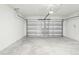 Spacious two-car garage with ample room for parking and storage, featuring a clean and well-maintained concrete floor at 2511 Linda Knoll Ln, Bartow, FL 33830