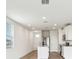 Bright kitchen with stainless steel appliances, white cabinetry, granite countertops, and tiled floors at 2511 Linda Knoll Ln, Bartow, FL 33830