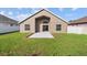 Backyard with green grass and privacy fence plus access to the home at 2524 Monaco Cove Cir, Orlando, FL 32825