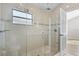Bathroom shower with glass enclosure, mosaic tile floor, window, and updated fixtures at 2524 Monaco Cove Cir, Orlando, FL 32825