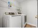 Modern laundry room with newer, front-loading Samsung washer and dryer at 2524 Monaco Cove Cir, Orlando, FL 32825