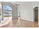 Bright, sunlit living room with high ceilings, fan, tile flooring, and backyard access at 2524 Monaco Cove Cir, Orlando, FL 32825