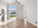 Living room featuring a ceiling fan, tile floors, arched window and sliding glass doors at 2524 Monaco Cove Cir, Orlando, FL 32825