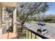 Balcony view showcasing the parking lot and mature trees at 3004 Parkway Blvd # 203, Kissimmee, FL 34747