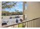 Unit balcony view displaying ample parking and lush greenery at 3004 Parkway Blvd # 203, Kissimmee, FL 34747
