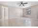 Spacious bedroom featuring neutral walls, tile flooring, and a bright window offering natural light at 3004 Parkway Blvd # 203, Kissimmee, FL 34747