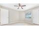 Neutral bedroom featuring tile flooring, a window, and ample closet space at 3004 Parkway Blvd # 203, Kissimmee, FL 34747