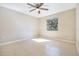 A bright bedroom featuring tile flooring, a ceiling fan, and a window letting in natural light at 3004 Parkway Blvd # 203, Kissimmee, FL 34747