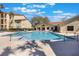 Inviting community pool surrounded by lush landscaping and building at 3004 Parkway Blvd # 203, Kissimmee, FL 34747