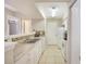 Kitchen featuring white cabinets, granite countertops, modern backsplash, and an open view into the living room at 3004 Parkway Blvd # 203, Kissimmee, FL 34747