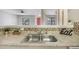 Kitchen featuring granite countertops, modern backsplash, and an open view into the dining and living area at 3004 Parkway Blvd # 203, Kissimmee, FL 34747