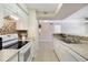 Bright kitchen with white cabinets, granite countertops and modern backsplash, seamlessly connects to the living area at 3004 Parkway Blvd # 203, Kissimmee, FL 34747