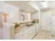 Kitchen featuring white cabinets, granite countertops, modern backsplash, and an open view into the living room at 3004 Parkway Blvd # 203, Kissimmee, FL 34747
