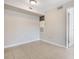 Minimalist living space showcasing tile floors, neutral walls, and convenient closet access at 3004 Parkway Blvd # 203, Kissimmee, FL 34747