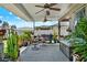 This covered patio is an oasis of plants and patio furniture and includes ceiling fans for comfort at 3086 Brenton Manor Loop, Winter Haven, FL 33881