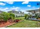 This well-maintained backyard has ample grass space, bordered garden beds, and a covered patio area at 3086 Brenton Manor Loop, Winter Haven, FL 33881
