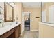 Bathroom featuring ceramic tile flooring, double sinks, and natural lighting at 3086 Brenton Manor Loop, Winter Haven, FL 33881