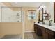 Bathroom with a shower, a window, and double sinks at 3086 Brenton Manor Loop, Winter Haven, FL 33881
