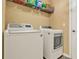 Well-equipped laundry room with a washer and dryer at 3086 Brenton Manor Loop, Winter Haven, FL 33881