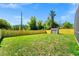 Spacious, verdant backyard featuring a wood fence and a storage shed, providing ample space at 3156 Natoma Way, Orlando, FL 32825