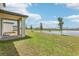 Peaceful backyard featuring a covered patio and a serene pond view, perfect for outdoor living at 3213 Viceroy Ct, Poinciana, FL 34759