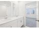 Bright bathroom features double sinks, plenty of counter space, and a view to the bedroom at 3213 Viceroy Ct, Poinciana, FL 34759