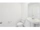 Elegant half bathroom with pedestal sink, modern fixtures, and a clean, minimalist design at 3213 Viceroy Ct, Poinciana, FL 34759