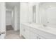 Modern bathroom boasts double sinks, sleek white cabinetry, and a spacious walk-in closet at 3213 Viceroy Ct, Poinciana, FL 34759