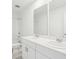 Bright white bathroom featuring double sinks, neutral flooring, and shower with tub at 3213 Viceroy Ct, Poinciana, FL 34759