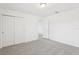 Bright bedroom features neutral carpeting, a ceiling light, and a closet for ample storage at 3213 Viceroy Ct, Poinciana, FL 34759
