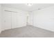 Light filled bedroom featuring neutral carpet, double closet and freshly painted white walls at 3213 Viceroy Ct, Poinciana, FL 34759