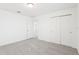 Bright bedroom featuring neutral carpet, freshly painted white walls, double closet, and ensuite bathroom at 3213 Viceroy Ct, Poinciana, FL 34759
