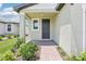 Charming front porch with brick walkway, lush landscaping, and an inviting entrance at 3213 Viceroy Ct, Poinciana, FL 34759