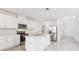 Modern kitchen with white cabinets, stainless steel appliances, and center island with breakfast bar at 3213 Viceroy Ct, Poinciana, FL 34759