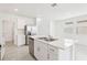 Bright eat-in kitchen with stainless steel appliances, white cabinets and center island with double sink at 3213 Viceroy Ct, Poinciana, FL 34759