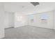 Spacious living room bathed in natural light with plush carpeting and bright white walls at 3213 Viceroy Ct, Poinciana, FL 34759
