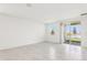 Open concept living room with tile flooring, bright natural light, and patio access at 3213 Viceroy Ct, Poinciana, FL 34759