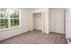 Bedroom with a large window, closet, and neutral carpet at 3222 Viceroy Ct, Kissimmee, FL 34759