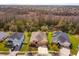 Aerial view of a single Gathering home, highlighting the surrounding neighborhood and wooded area at 3783 Moon Dancer Pl, St Cloud, FL 34772