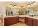 Luxurious bathroom with double vanity, large mirrors, and ceramic tile flooring at 3783 Moon Dancer Pl, St Cloud, FL 34772