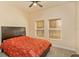Bedroom featuring a dark wooden bedframe, ceiling fan, and two windows at 3783 Moon Dancer Pl, St Cloud, FL 34772