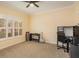 Bright bedroom with neutral carpet, a ceiling fan, and ample natural light from a large window at 3783 Moon Dancer Pl, St Cloud, FL 34772