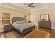 Spacious bedroom with wood flooring, a large bed, and ample natural light at 3783 Moon Dancer Pl, St Cloud, FL 34772