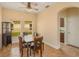 Elegant dining area with tiled floor, wood dining set and wine rack, adjacent to kitchen at 3783 Moon Dancer Pl, St Cloud, FL 34772