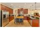 Spacious kitchen with cherry wood cabinets, granite countertops, stainless appliances, and center island at 3783 Moon Dancer Pl, St Cloud, FL 34772